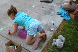 Young girl creating chalk art