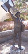 Bronze newsboy statue