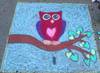 Chalk owl on tree branch